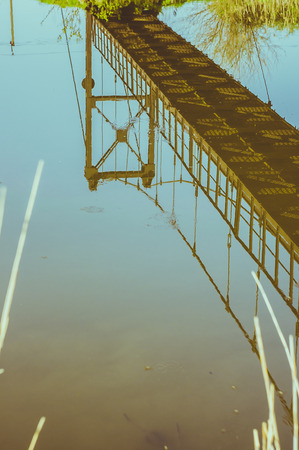Reflection of old bridge in the waterの写真素材