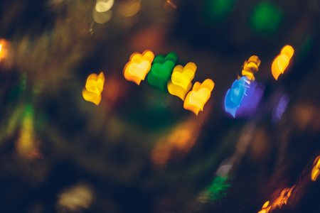 Abstract blurred colorful christmas bokeh background heart shape. Toned, style photo.の写真素材