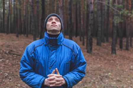 A rural guy posing in a pine forest in the autumn timeの写真素材