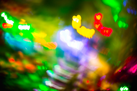 Abstract blurred colorful christmas bokeh background heart shape. Toned, style photo.の写真素材