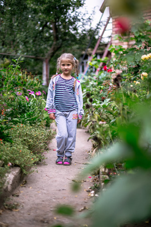 Portrait of a little girl in the gardenの写真素材