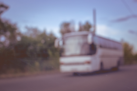 Blurred photo of bus on the roadの写真素材