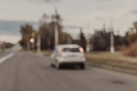 Blurred photo of car on the roadの写真素材