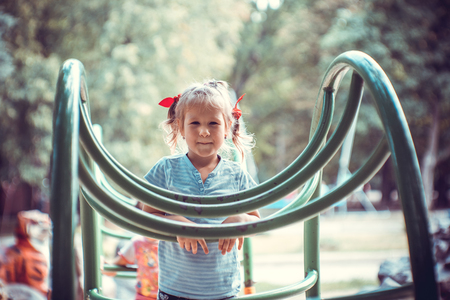 Cute little girl on the playgroundの写真素材