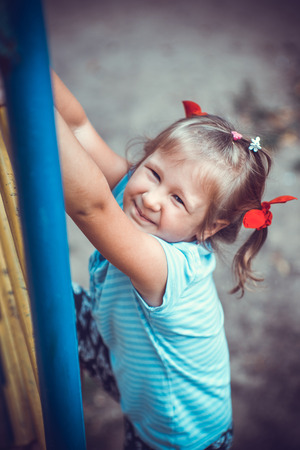 Cute little girl on the playgroundの写真素材