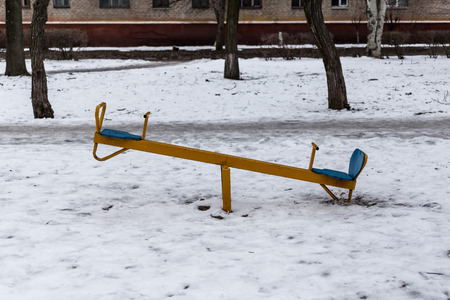 Old empty children playground in winter time.の写真素材