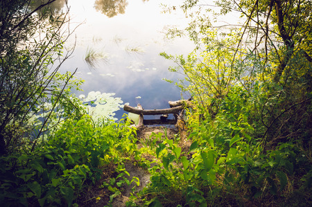 A place for fishing on the lake in the summer at sunriseの写真素材
