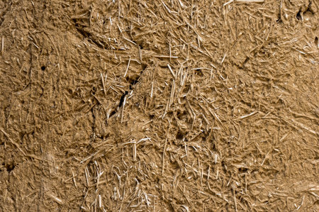 Texture of an old wall of an old house made of clay and straw