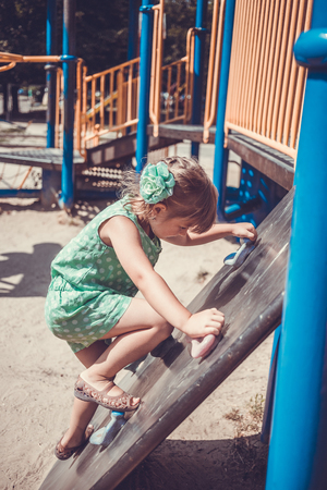 Little girl on the playground in summerの写真素材