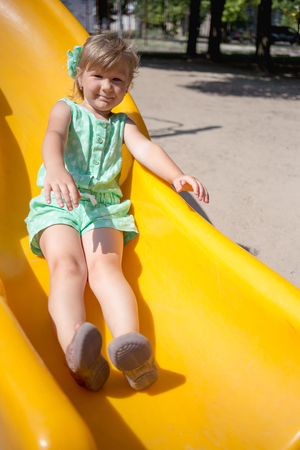 Little girl on the playground in summerの写真素材