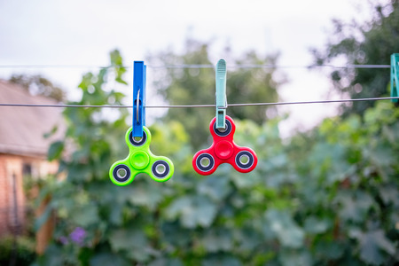 Fidget spinners on wire with clothespinsの写真素材