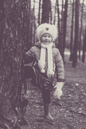 Cute little girl posing in autumn forestの写真素材