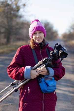 Woman with a camera on a tripod.