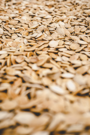 Raw pumpkin seeds background for design.の写真素材