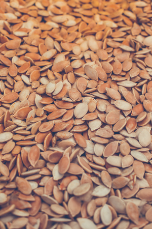 Raw pumpkin seeds background for design.の写真素材