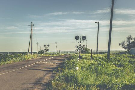 Old railway crossing in spring time.の写真素材