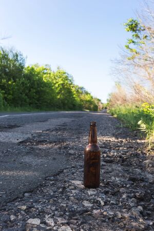 Beer bottle by the road. Environmental pollution conceptの写真素材