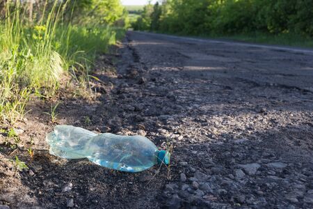 Plastic bottle with water by the road. Environmental pollution concept.の写真素材