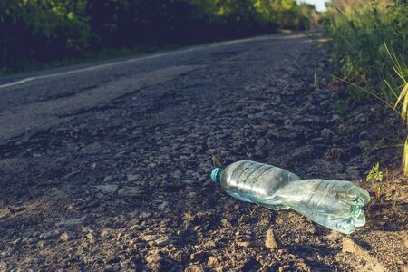 Plastic bottle with water by the road. Environmental pollution concept.の写真素材