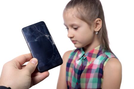 Cute little girl with broken smartphone on white backgroundの写真素材