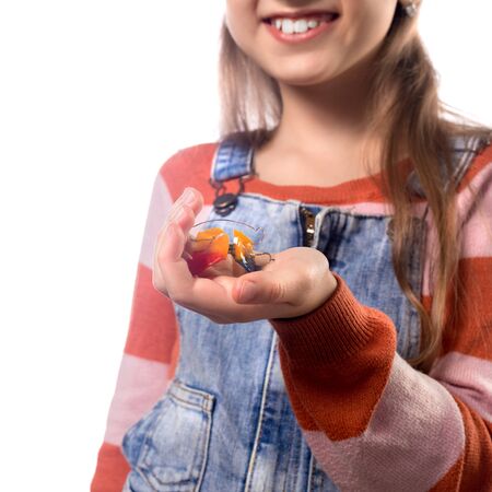 Portrait of little girl with orthodontics appliance isolated on white background.の写真素材