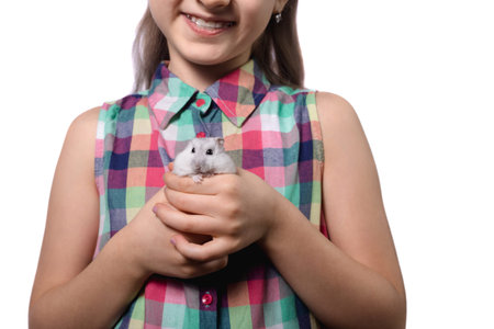 Cute little girl with white hamster isolated on white backgroundの写真素材