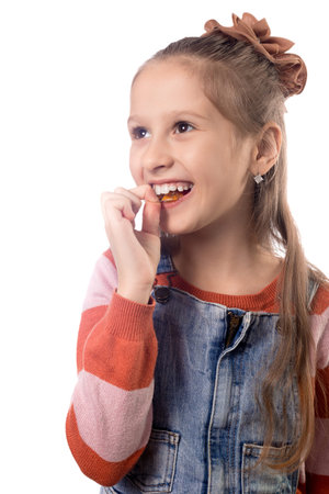 Portrait of little girl with orthodontics appliance isolated on white background.