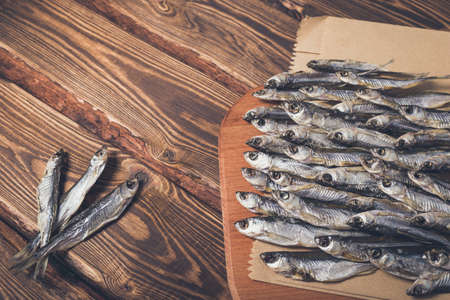 Dried fish on a wooden background. Studio photo.の写真素材