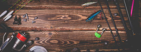 Fishing tackle on a wooden background. Studio photo with vignetting.の写真素材