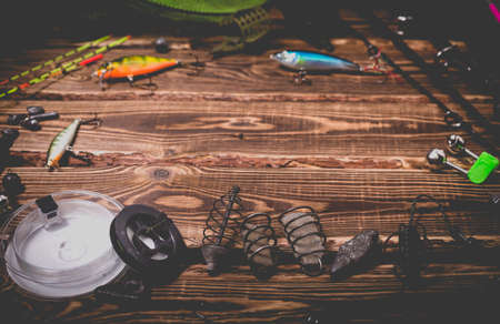 Fishing tackle on a wooden background. Studio photo with vignetting.の写真素材