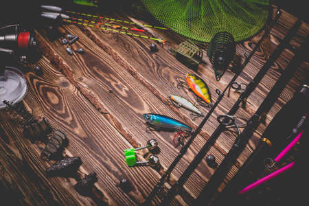 Fishing tackle on a wooden background. Studio photo with vignetting.の写真素材