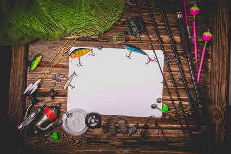 Fishing tackle on a wooden background. Studio photo with vignetting.の写真素材