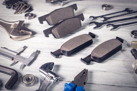 New car brake pads on a white wooden