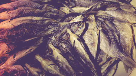 Heap of dry crucians in a bowl. The concept of cooking dried fish at home.の写真素材