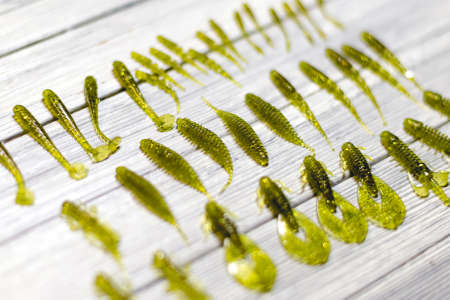 Nice view of fishing silicone baits on a wooden background. Studio photoの写真素材