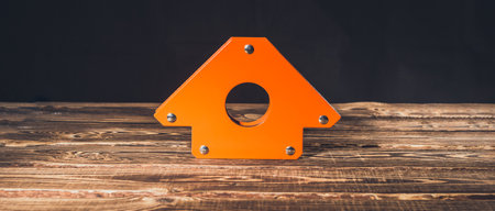 Magnetic corner for welding on a wooden background. A studio photo with hard lighting.の写真素材