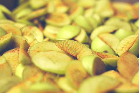 The process of home cooking dried fruits in an electric dryer. The stage of dehydration of fruits for storage and consumption in the winter. Lots of dehydrated apples.の写真素材