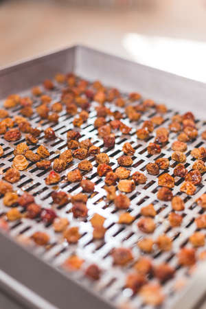 The process of cooking dry yellow cherries in an electric automatic dryer at home.の写真素材