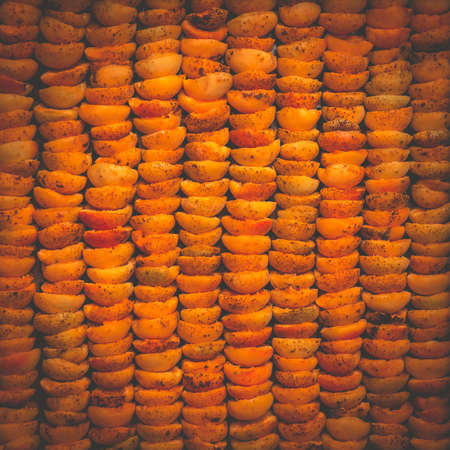 The process of home cooking dried fruits in an electric dryer. The stage of dehydration of fruits for storage and consumption in the winter. Lots of dehydrated apricots.の写真素材