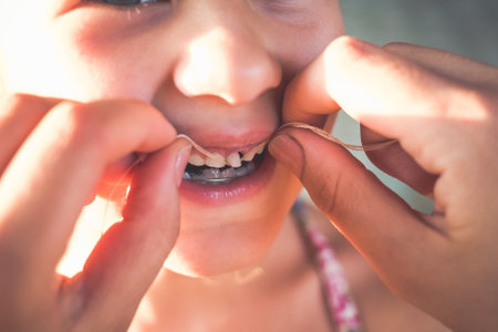 The process of removing a baby tooth using a thread.の写真素材