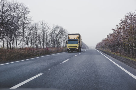 Truck on the road in the autumn.の写真素材