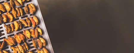 The process of home cooking dried fruits in an electric dryer. The stage of dehydration of fruits for storage and consumption in the winter. Lots of dehydrated apricots.の写真素材