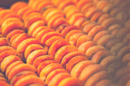 The process of home cooking dried fruits in an electric dryer. The stage of dehydration of fruits for storage and consumption in the winter. Lots of dehydrated apricots.の写真素材