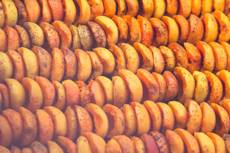 The process of home cooking dried fruits in an electric dryer. The stage of dehydration of fruits for storage and consumption in the winter. Lots of dehydrated apricots.の写真素材