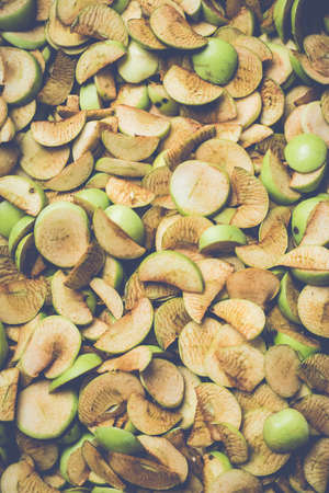 The process of home cooking dried fruits in an electric dryer. The stage of dehydration of fruits for storage and consumption in the winter. Lots of dehydrated apples.の写真素材