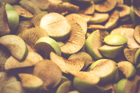 The process of home cooking dried fruits in an electric dryer. The stage of dehydration of fruits for storage and consumption in the winter. Lots of dehydrated apples.の写真素材