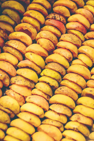 The process of home cooking dried fruits in an electric dryer. The stage of dehydration of fruits for storage and consumption in the winter. Lots of dehydrated apricots.の写真素材