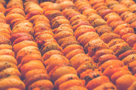 The process of home cooking dried fruits in an electric dryer. The stage of dehydration of fruits for storage and consumption in the winter. Lots of dehydrated apricots.の写真素材