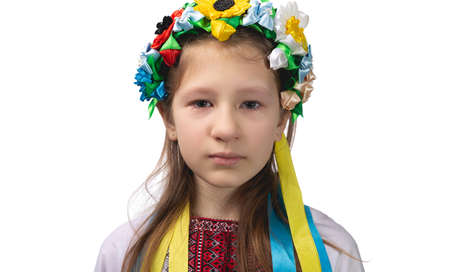 Portrait of a little Ukrainian girl with tearful eyes. Child in national dress. Studio photo on a white background.の写真素材
