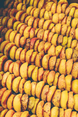 The process of home cooking dried fruits in an electric dryer. The stage of dehydration of fruits for storage and consumption in the winter. Lots of dehydrated apricots.の写真素材
